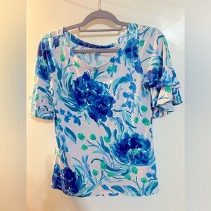 Lilly Pulitzer blue floral. Ruffle sleeves. Size S. Background is soft white.